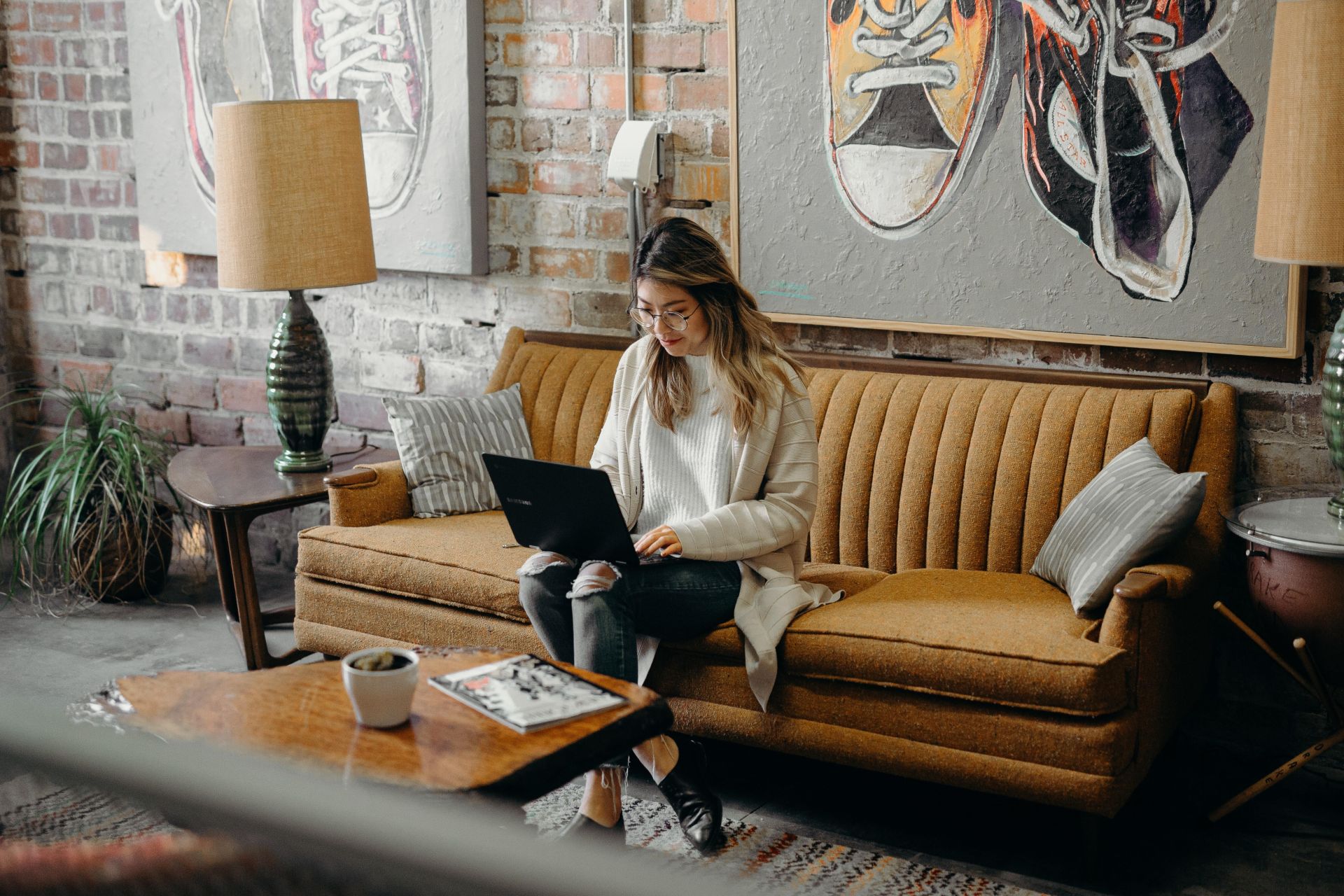 Woman working at a laptop in a quiet coffee shop