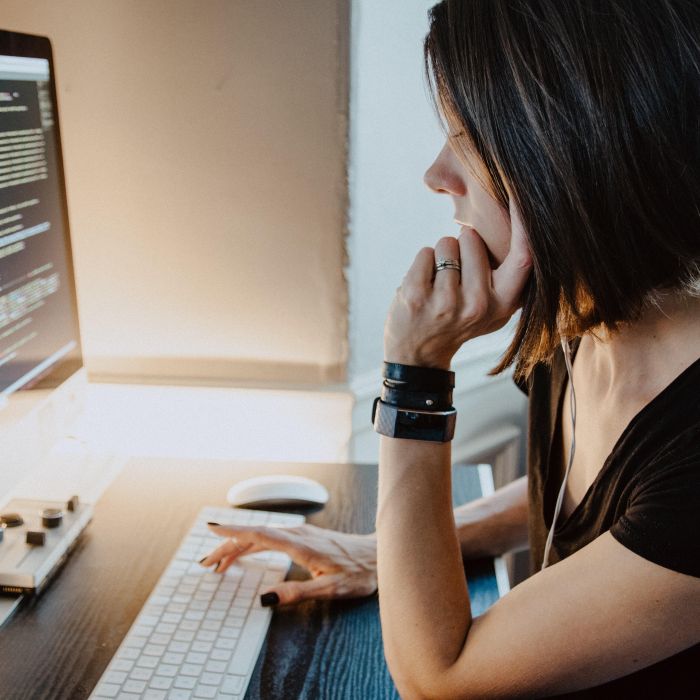 Young woman learning to code at a computer