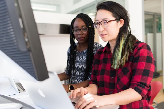 Two women working on some code